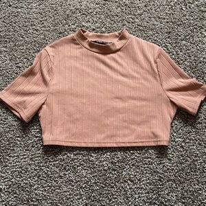 Cropped fit, blush colored high neck tee